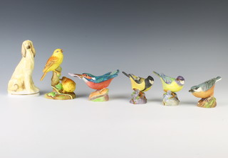 A Royal Worcester figure of a Kingfisher 3235 7cm, a Great Tit 3335 6cm, a Great Tit 7cm, a Nuthatch 3334 7cm, Yellow Hammers 3377 13cm and an Afghan model by Kenneth Potts 14cm 
