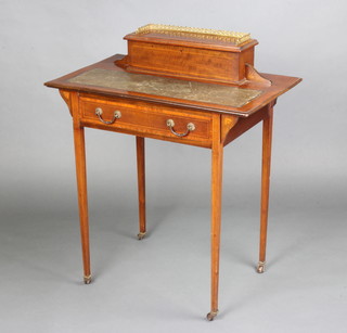 An Edwardian inlaid mahogany writing table with inset writing surface, the fitted stationery box top with brass 3/4 gallery, the base fitted a drawer and raised on square tapered supports, brass caps and casters 90cm h x 76cm w x 46cm d 