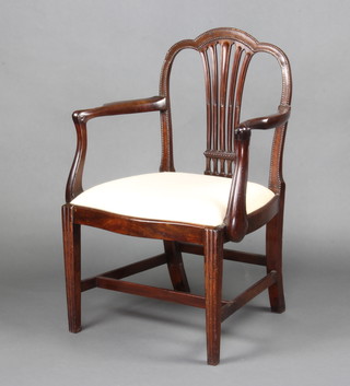 A Georgian mahogany Hepplewhite style open arm carver chair of serpentine outline, with vase shaped slat back and upholstered drop in seat, raised on tapered supports with H framed stretcher 