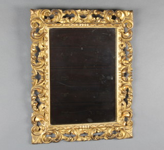 A rectangular plate wall mirror contained in a carved and pierced gilt wood frame 53cm h x 42cm w 