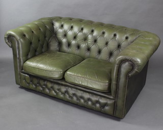 A 2 seat chesterfield settee upholstered in green buttoned leather 70cm h x 152cm w x 85cm d 