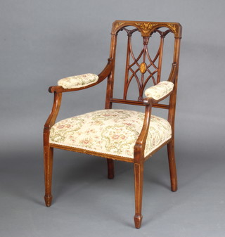 An Edwardian inlaid mahogany open armchair with pierced slat back and upholstered seat raised on square tapered supports, spade feet