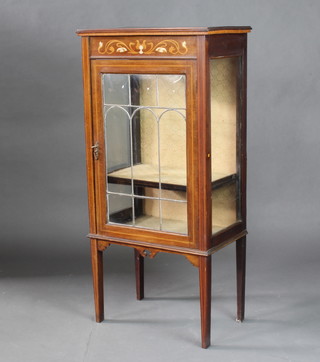 An Edwardian Art Nouveau inlaid mahogany display cabinet enclosed by lead glazed panelled doors, raised on square tapered supports 117cm h x 56cm w x 34cm d 
