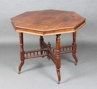 An Edwardian octagonal walnut occasional table raised on turned supports and X framed stretcher with bobbin turned decoration 71cm h x 90cm w x 91cm (splits and ink marks to the top)  