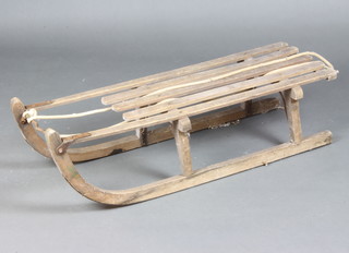 A vintage steel and wooden framed sleigh 24cm h x 95cm l x 26cm w 