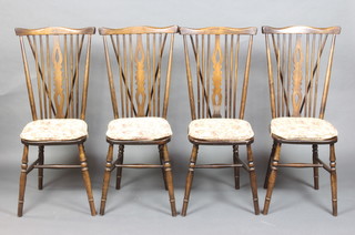 A set of 4 beech framed stick  back chairs with solid seats, on turned supports