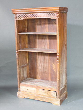An Indonesian hardwood bookcase with moulded cornice and fretwork apron, fitted adjustable shelves, the base fitted 2 drawers 186cm h x 104cm w x 46cm d 