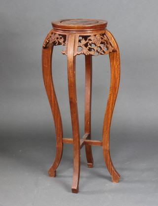 A circular Indonesian pierced and carved hardwood jardiniere stand 90cm h x 30cm diam. 