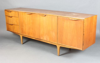 A mid 20th Century teak sideboard fitted 3 drawers flanked by cupboards and cocktail unit, raised on turned supports 75cm h x 201cm w x 46cm d (some staining and marks overall) 