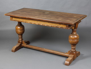 A 1930's oak "surprise" drawleaf dining table raised on bulbous turned supports with H framed stretcher 77cm x 136cm x 61cm 