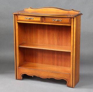 A Younger  French style walnut bookcase of serpentine outline with raised back, the base fitted 2 long drawers above  adjustable shelves 87cm h x 82cm w x 28cm d 