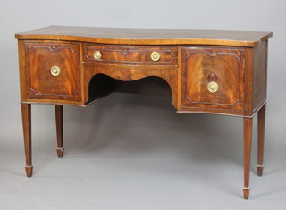 A Georgian style mahogany sideboard of serpentine outline with crossbanded top, fitted 1 long drawer flanked by a cupboard and drawer, raised on square tapered supports, spade feet 92cm h x 151cm w x 60cm d