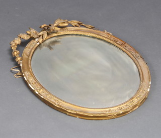 A 19th Century oval plate wall mirror contained in a decorative gilt frame with swag garland decoration 63cm x 50cm 