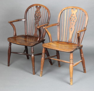 A 19th Century elm wheel back kitchen carver chair with solid seat and crinoline stretcher (old repair to the arm) together with 1 other elm kitchen carver chair with turned supports, H framed stretcher 