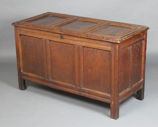 An 18th Century oak coffer of panelled construction with hinged lid, the interior fitted a candle box 70cm h x 119cm w x 55cm d 