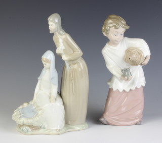 A Nao figure of a boy pouring into a jug 22cm and a ditto of Joseph, Mary and the baby Jesus 23cm 
