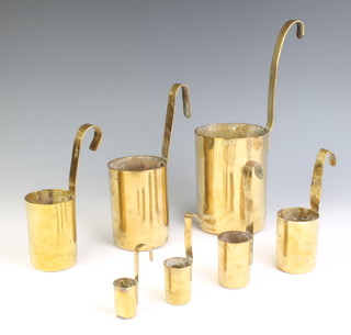Seven brass measures marked The Oriental Pressing Works, the cups marked 1 seer, 1/2 seer, 1/4 seer, 1/6, 1/16, 1/32 and 1/64 