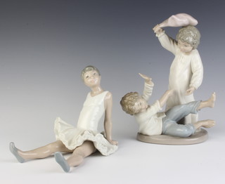 A Nao figure of a seated ballerina 17cm, ditto of two boys playing 24cm 