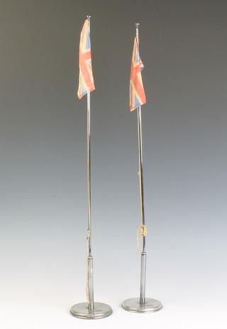 Of Merchant Navy interest, a pair of Wilson Line chrome table flag holders complete with hoisted Union flags 60cm h x 9cm diam. to the base 