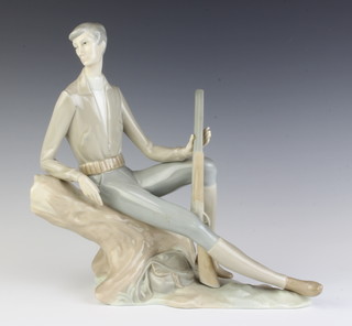 A Nao figure of a huntsman reclining on a tree trunk 28cm 