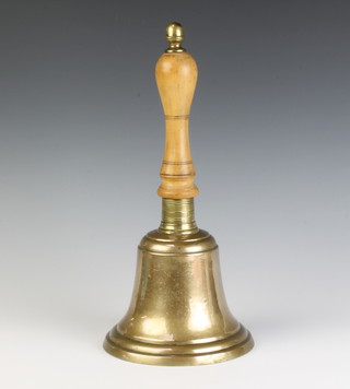 A brass hand bell with turned wooden handle 