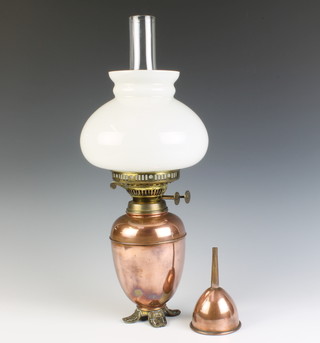A 19th Century polished copper oval oil lamp with opaque glass shade and clear glass chimney together with a matching copper funnel 
