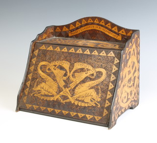 A wooden Art Nouveau Arts and Crafts wedge shaped stationery box, the 3/4 gallery carved a dragon and marked "There's gladness in remembrance", the fall front carved 3 stylised entwined dragons with shelved interior, the fall carved a green man 20cm h x 23.5cm w x 17cm d 