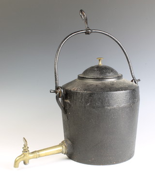 A Victorian circular cast iron tea kettle with swing handle and brass spicket 21cm x 25cm diam. 
