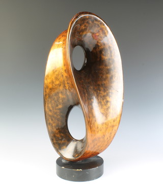 After Barbara Hepworth, a gilt and black coloured sculpture, raised on a circular base 62cm x 27cm x 19cm  
