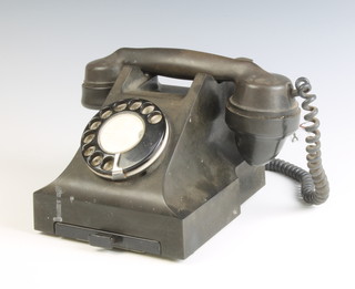A black Bakelite dial telephone 