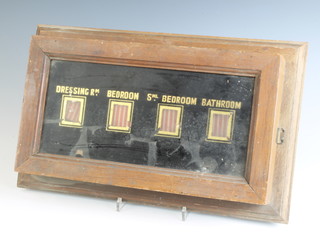 A mahogany cased 4 aperture servants bell indicator board marked Dressing Room, Bedroom, Small Bedroom, Bathroom 