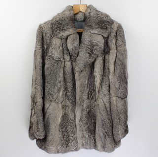 A lady's silver fur jacket together with a lady's quarter length simulated fur jacket and full length ditto 