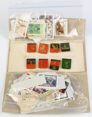Eight Soviet Russian lapel pins and a collection of ditto stamps 