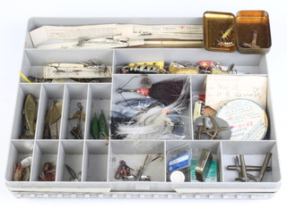 A rectangular plastic box containing a collection of vintage lures and mounts, some on card including Allcocks Aquaspiders