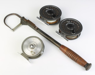 A brass and metal 3 draw pike fishing gaff, 2 Leeda rimfly concept 375 reels and a centre pin fishing reel 