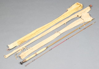 A J A Lupton 8'6" 2 piece split cane fly fishing rod, an Alcock 7' split cane fly rod and a 7' split cane spinning rod with red agate eyes throughout, all contained in 3 cloth bags 