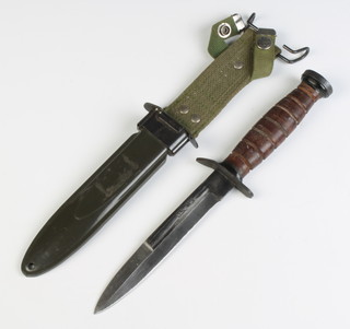 An American M3 fighting knife with 16cm blade marked U.S. M3 complete with scabbard