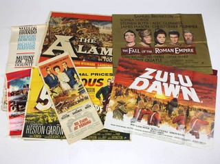 A collection of UK and International movie posters comprising five UK quads - The Alamo (in poor condition), 55 Days at Peking (poor condition), The Fall of the Roman Empire, Zulu Dawn, a US one sheet of Mutiny and the Bounty (poor condition), a US insert 55 Days That Stunned the World, an Italian locandina Zulu, a French grande Le 55 Jours de Pekin  