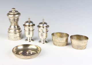A coin set silver dish, pepper mill, pair of pepper pots and salts