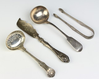 A Victorian silver sifter spoon, London 1849, a ladle sugar nips and butter knife 