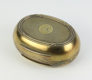 An Edwardian oval silver trinket box with engine turned decoration and chased monogram London 1907, Maker Norman Marshall 148 grams, 10cm 