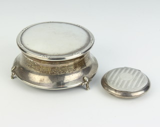 A circular silver trinket box Birmingham 1912, 9cm together with a ditto compact