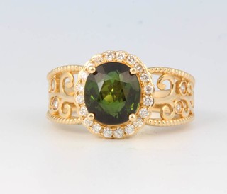 A 14ct yellow gold tourmaline and diamond ring, the oval centre stone approx 2.95ct surrounded by brilliant cut diamonds approx. 0.25ct size M 