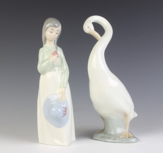 A Nao figure of a goose 23cm and a ditto girl holding her hat 23cm