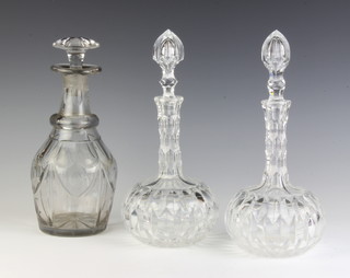 A pair of cut glass mallet shaped decanters and stoppers 28cm, a faceted ditto with mushroom stopper 26cm 