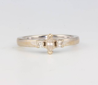 An 18ct white gold diamond ring with a marquise cut stone flanked by brilliant cut diamonds size N 