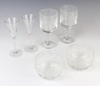 Two modern cordials with twist stems 18cm, 2 commemorative glass wines by Dartington 2962/5000 18cm and 2 faceted bowls with vinous decoration 