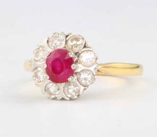 An 18ct yellow gold oval ruby and diamond cluster ring, the centre stone 0.5ct surrounded by 8 brilliant cut diamonds each approx 0.10ct, size Q 1/2