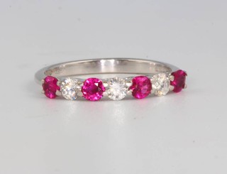 An 18ct white gold ruby and diamond 7 stone ring size O