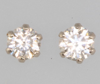 A pair of platinum single stone diamond set ear studs, approx. 0.3ct